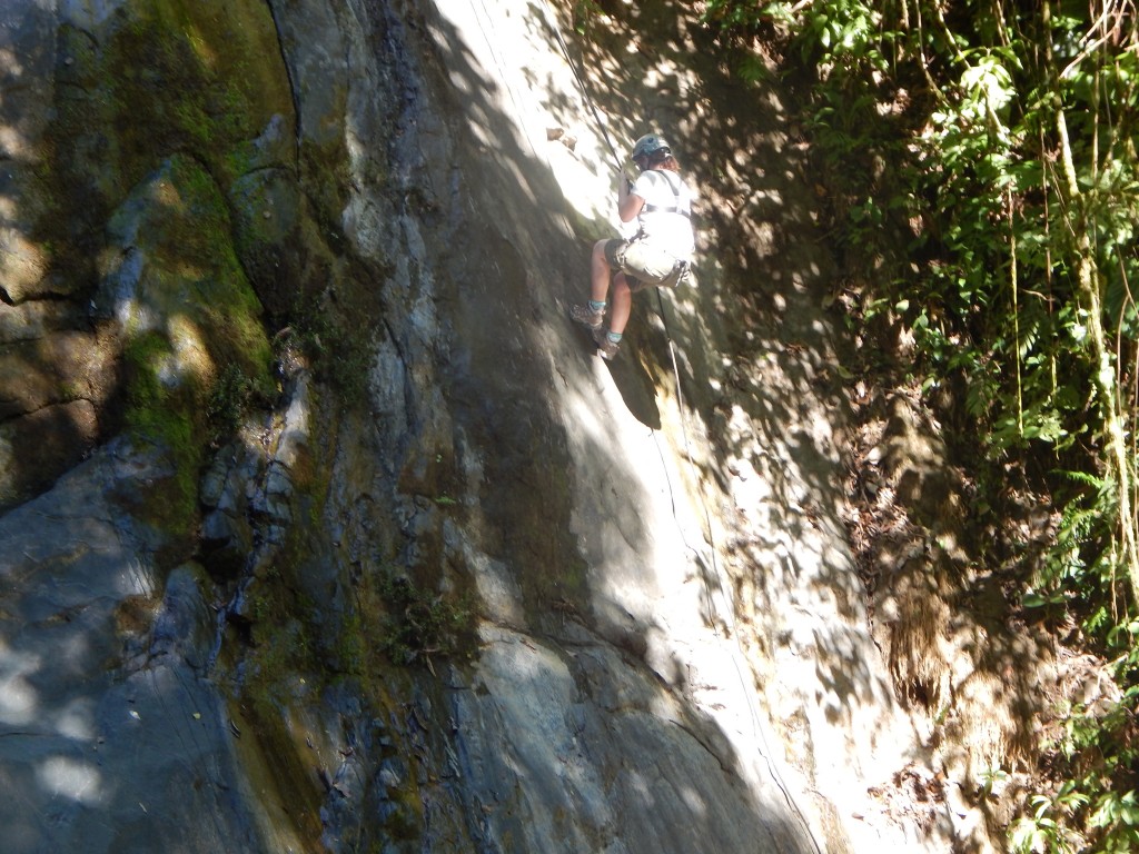 Mariah rappeling down the rock face.