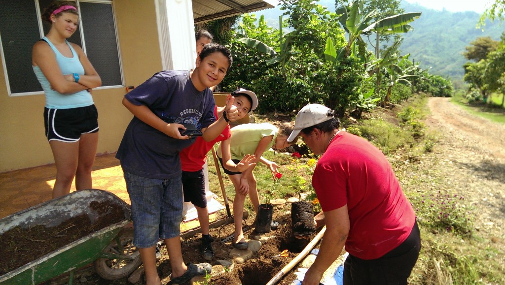 Planting roses in front of the church.